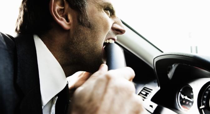 Frustrated angry man stuck in traffic (road rage)