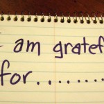 A gratitude journal with the words "I am grateful for..." written at the top of the page