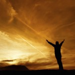 Person expressing gratitude by opening up to the sky