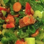 A big salad with carrots, beans, kale, cucumber, apple and more
