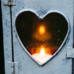 Candle flame inside a lantern with a heart shaped window