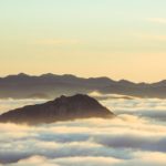 Mountaintops surrounded by clouds