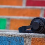 Set of headphones with a colourful brick background to represent listening to an audio journal entry